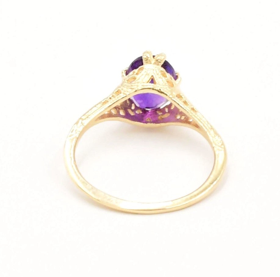Kent Island Jewelry Estate 14k YG Amethyst Open Work Textured Ring with large purple stone, side view on white.