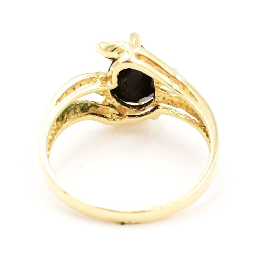Kent Island Jewelry Estate 14k YG ring features a .02ct diamond and onyx in an open swirl setting, viewed from the back.