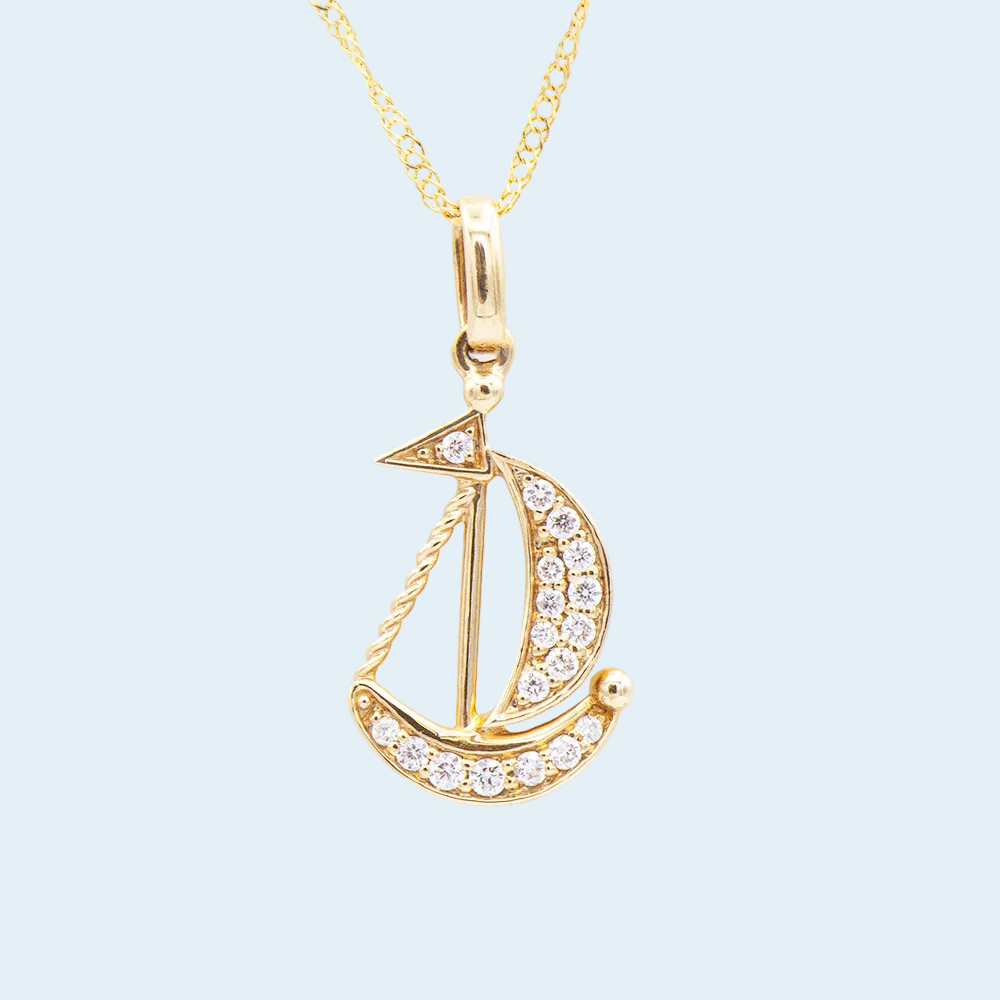 Gold sailboat pendant necklace with diamonds on a blue background