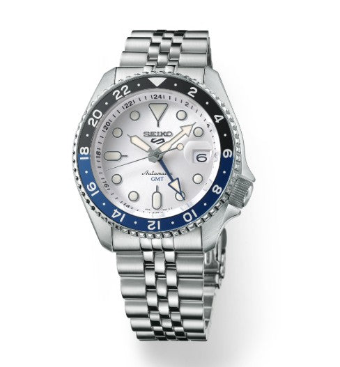 Seiko 5 Sports SKX GMT automatic watch with silver bracelet and blue-black bezel, shows time and date.