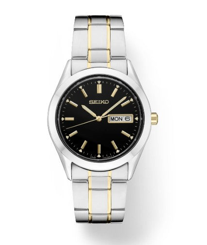 Seiko Essentials SS TT Quartz watch with black dial, gold accents, two-tone band, and day-date display.