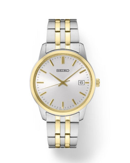 Seiko Essentials SS TT Quartz watch with a silver-gold band, white dial, gold markers, and date at 3 o’clock.