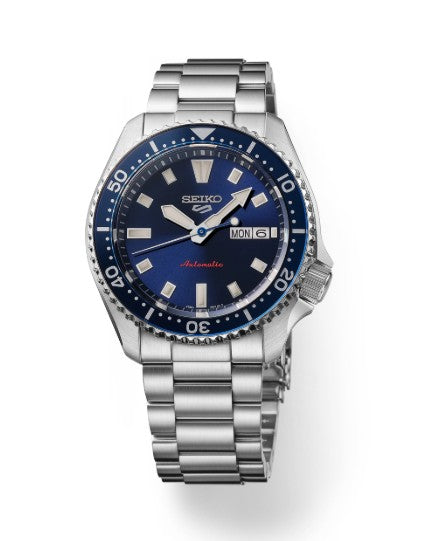 Seiko 5 Sports SS automatic watch with blue dial, stainless steel band, and day-date display.