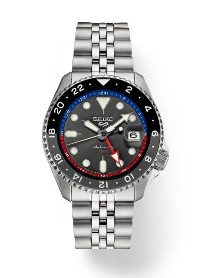 The Seiko 5 Sports SS Automatic GMT features a charcoal dial, date at 3, and a silver metal band by Seiko.