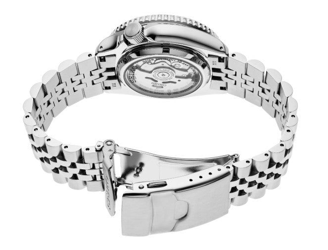 Seiko 5 Sports SS Automatic GMT with charcoal dial, open metal clasp, and visible internal movement in back view.