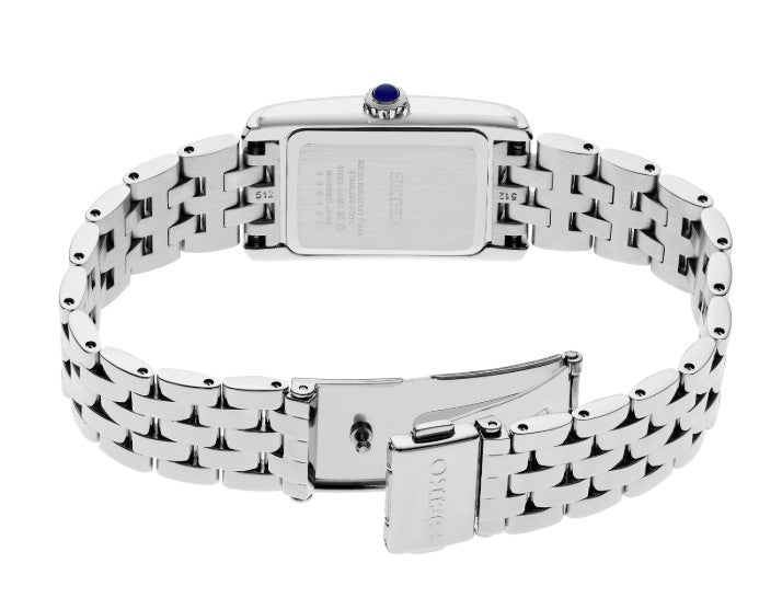 Seiko Essentials SS Quartz Watch with white dial, stainless steel bracelet, and blue gem on the crown.