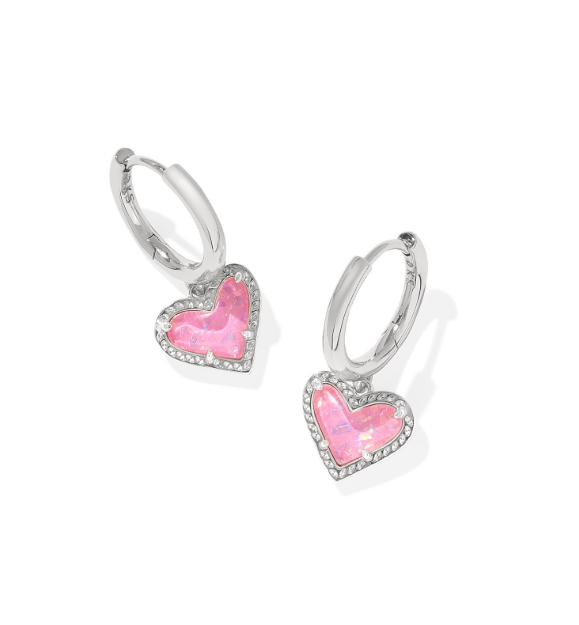 Kendra Scott ARI Heart Huggie Earrings in silver with pink iridescent glitter glass, shown on white.