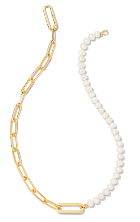 The Kendra Scott ASHTON Half Chain Necklace features gold links and white pearls in a modern, curved design.