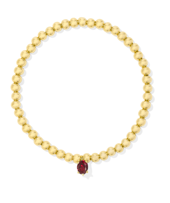 Kendra Scott CAILIN stretch bracelet in gold with a single red crystal, shown on a white background.
