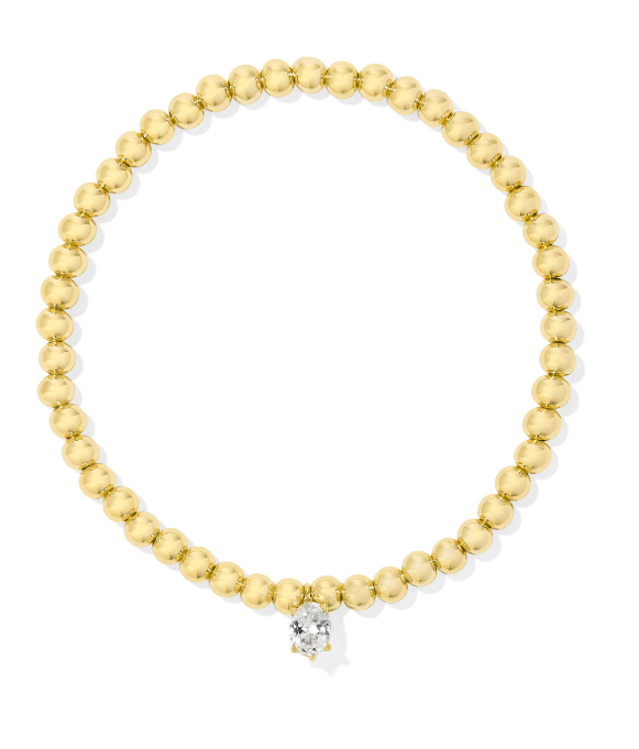 Kendra Scott CAILIN stretch bracelet in gold with a single white crystal accent at the center.
