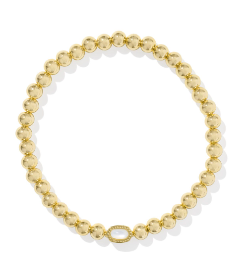 Kendra Scott MINI ELAINA Stretch Bracelet in Gold Ivory Mother of Pearl, paired with a gold beaded necklace.