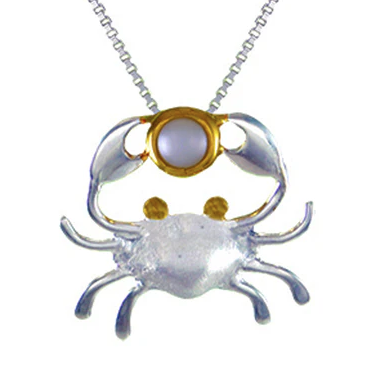 Michou’s SS and 22K Gold Vermeil Crab Pendant with White Freshwater Pearl hangs from a sleek chain necklace.