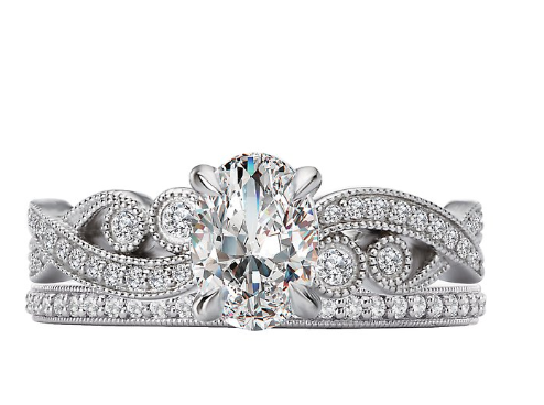 The Romance Diamond Semi-mount Engagement Ring features an oval center and a milgrain paisley diamond band in white gold.