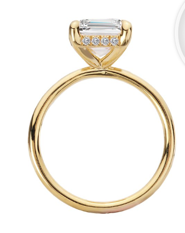 The Romance Diamond Hidden Halo Engagement Ring features an emerald-cut semi-mount in 14kt yellow gold.