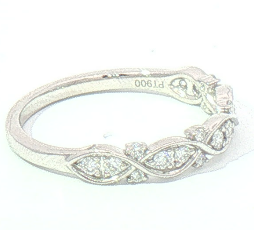 A platinum diamond ring with marquise-cut and round diamonds set in a decorative openwork pattern, shown on a plain white background. 