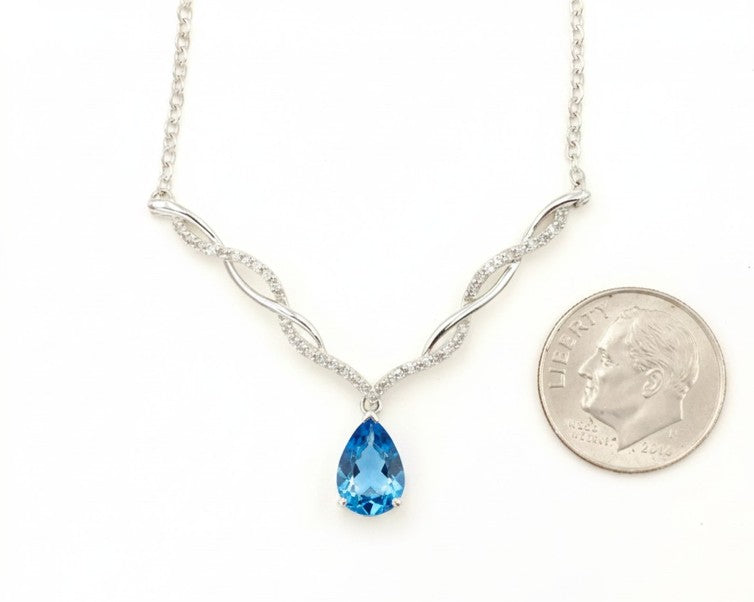 Kent Island Jewelry Estate 10K White Gold Blue Topaz & Diamond Accent Necklace shown beside a dime for scale.
