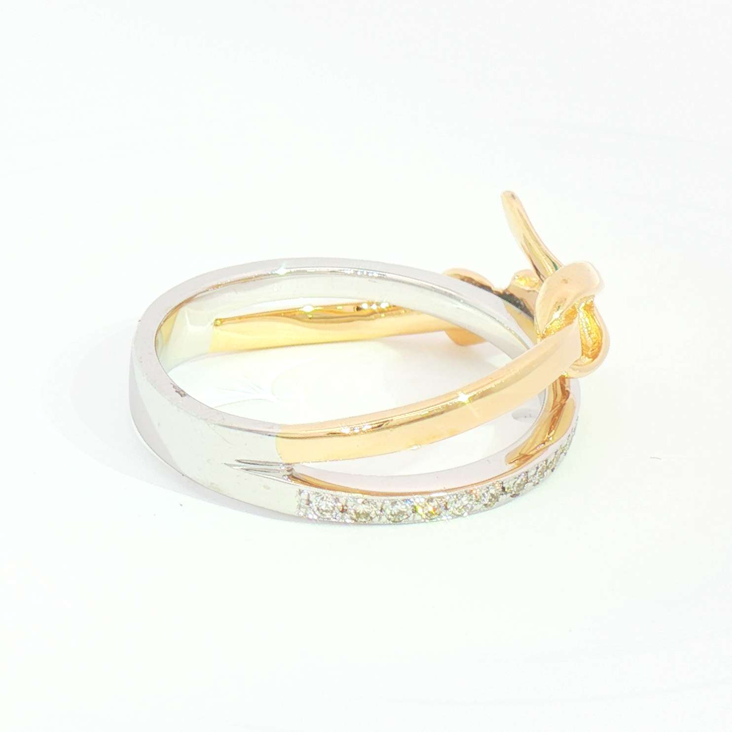 Heera Moti 14k Diamond Crossover Fashion Ring in gold and silver with a bow, shown on a white background.