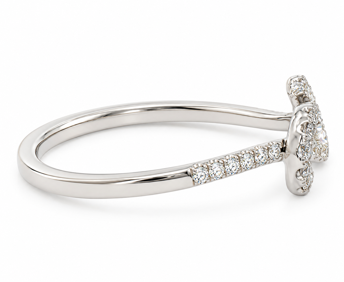 A white gold diamond ring with a curved band and a decorative end pavé-set with clear gemstones, shown on a clean white background.