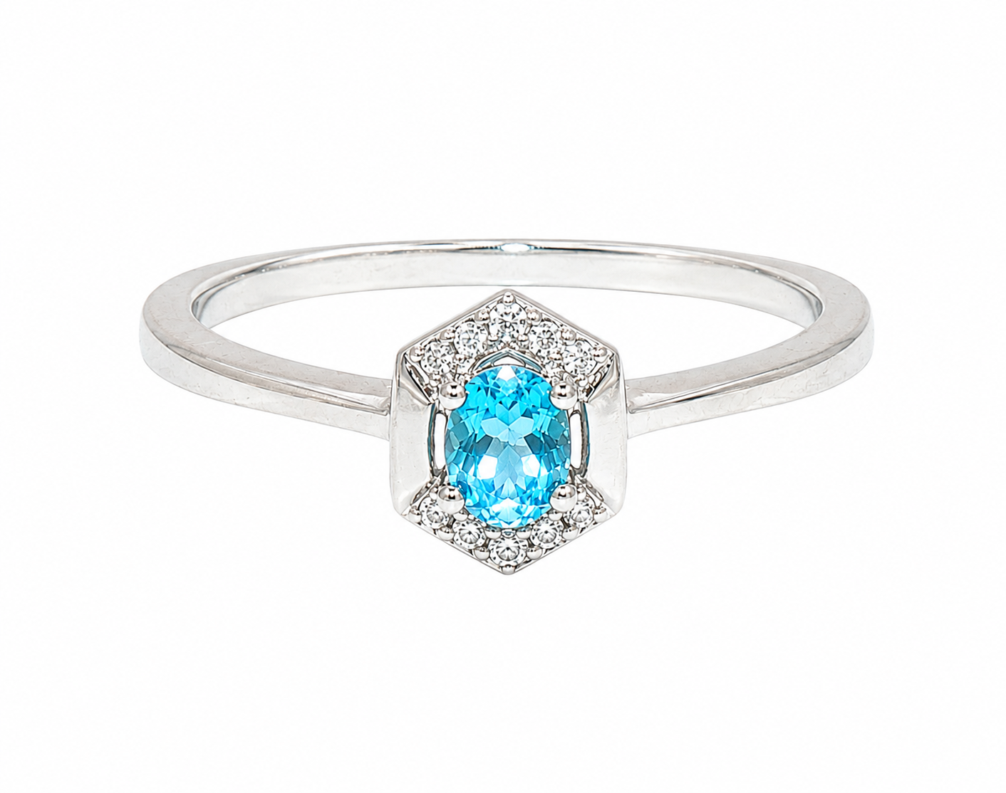 A white gold ring featuring a central oval-cut light blue gemstone surrounded by a halo of small clear stones, set on a polished silver band, shown against a plain white background.