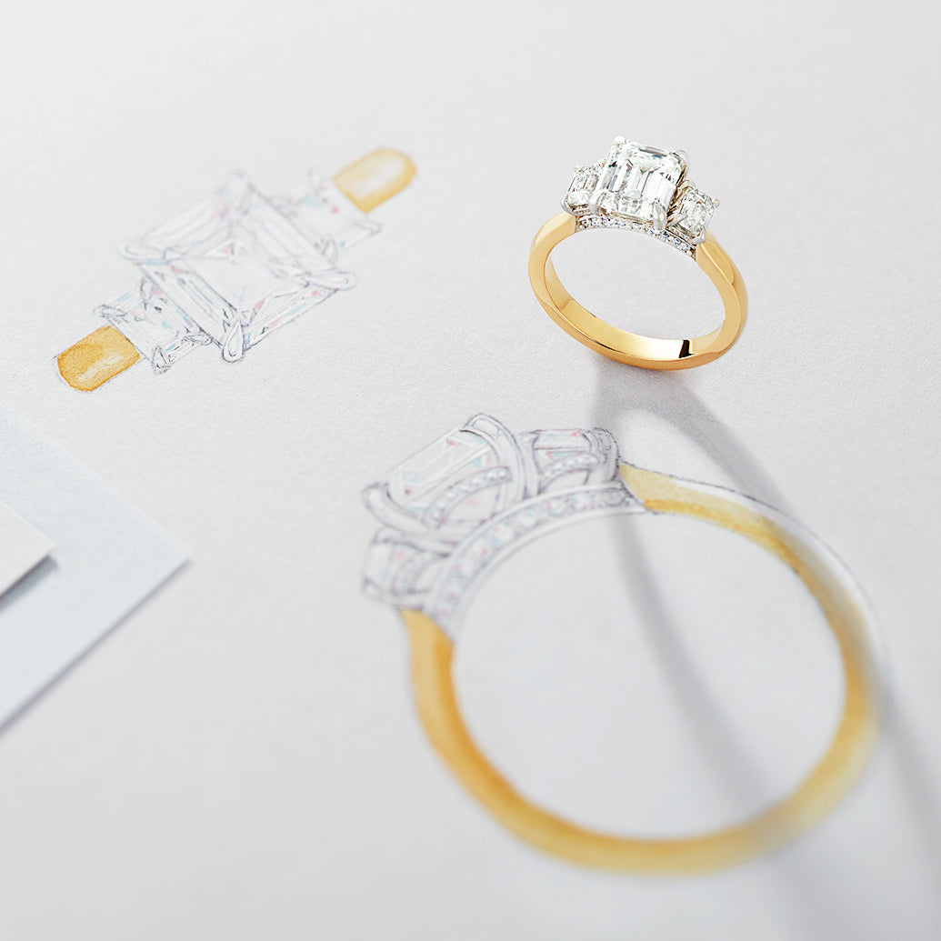 Gold and silver ring with diamond accents on a light gray background with drawings of the same ring.