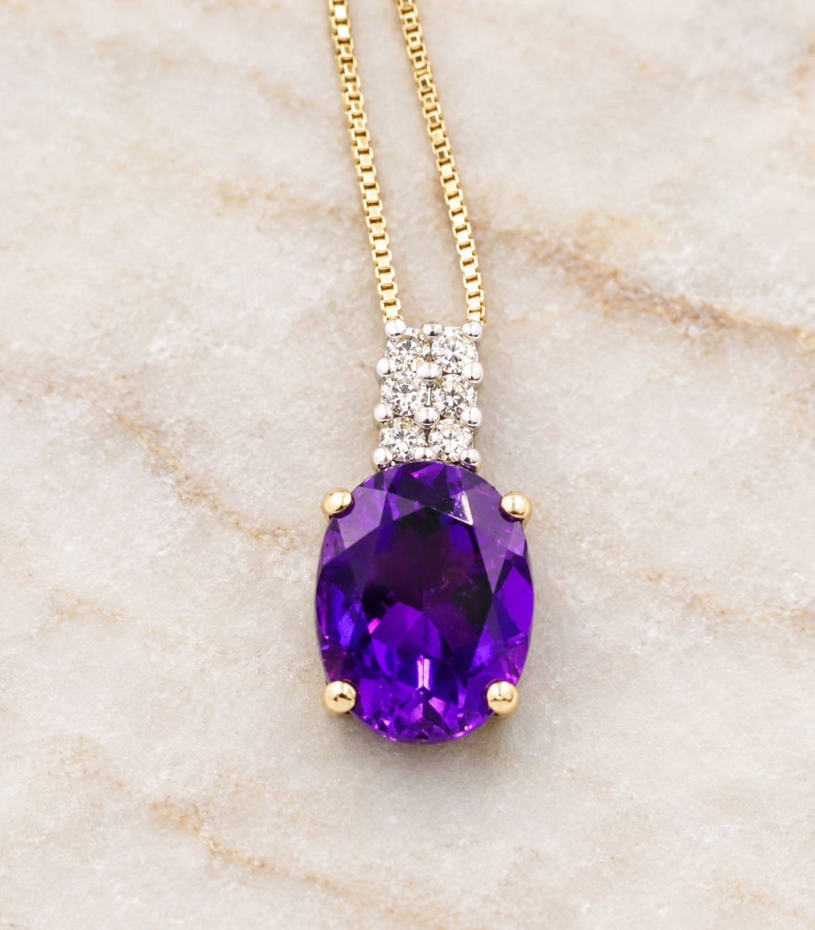 An oval amethyst and diamond pendant on an Estate 14k Yellow Gold Diamond & Amethyst Gemstone Box Chain Link Necklace.