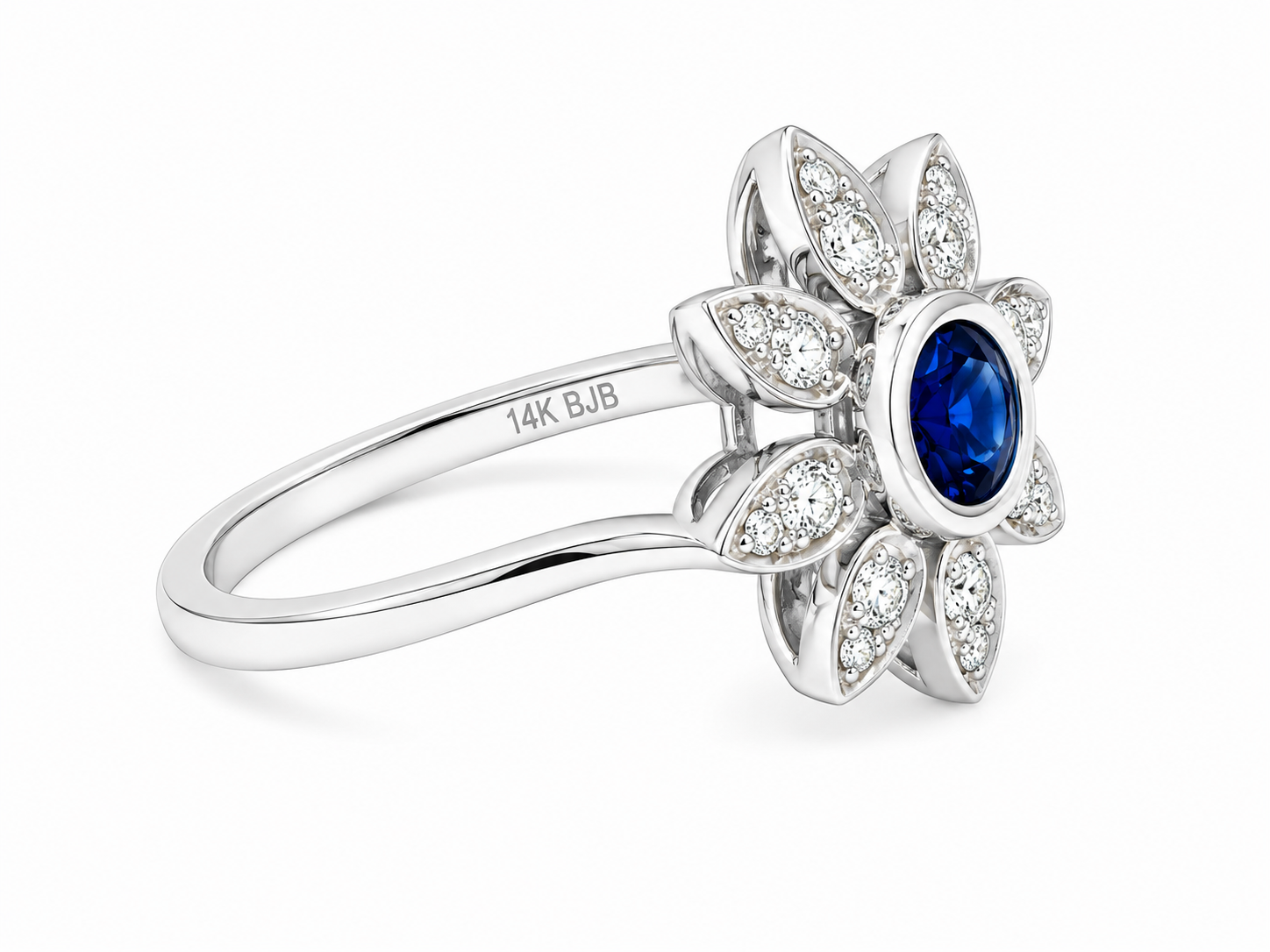 A white gold flower-shaped ring featuring a central oval blue sapphire surrounded by six petal clusters of small round diamonds.