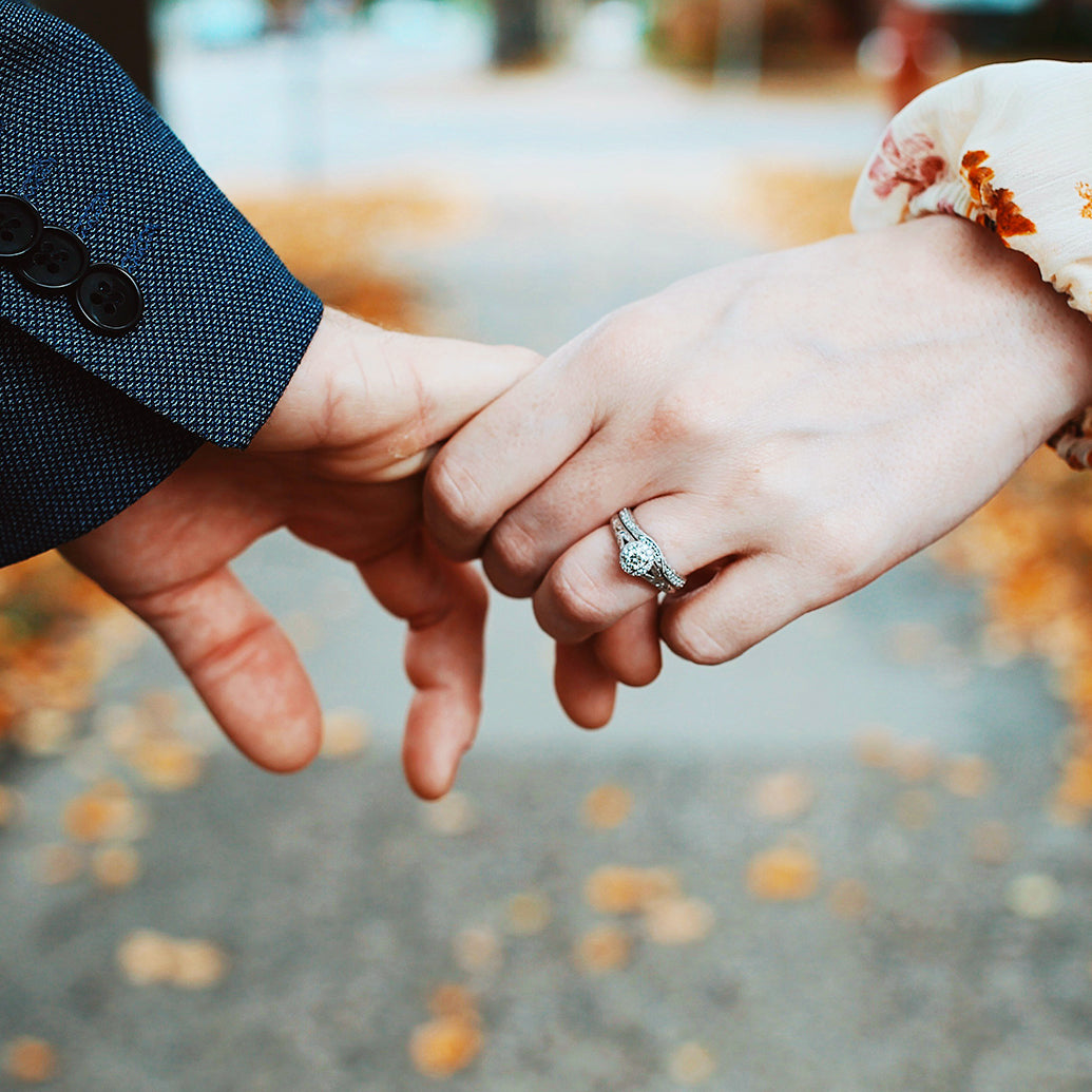 Two hands with engagement ring