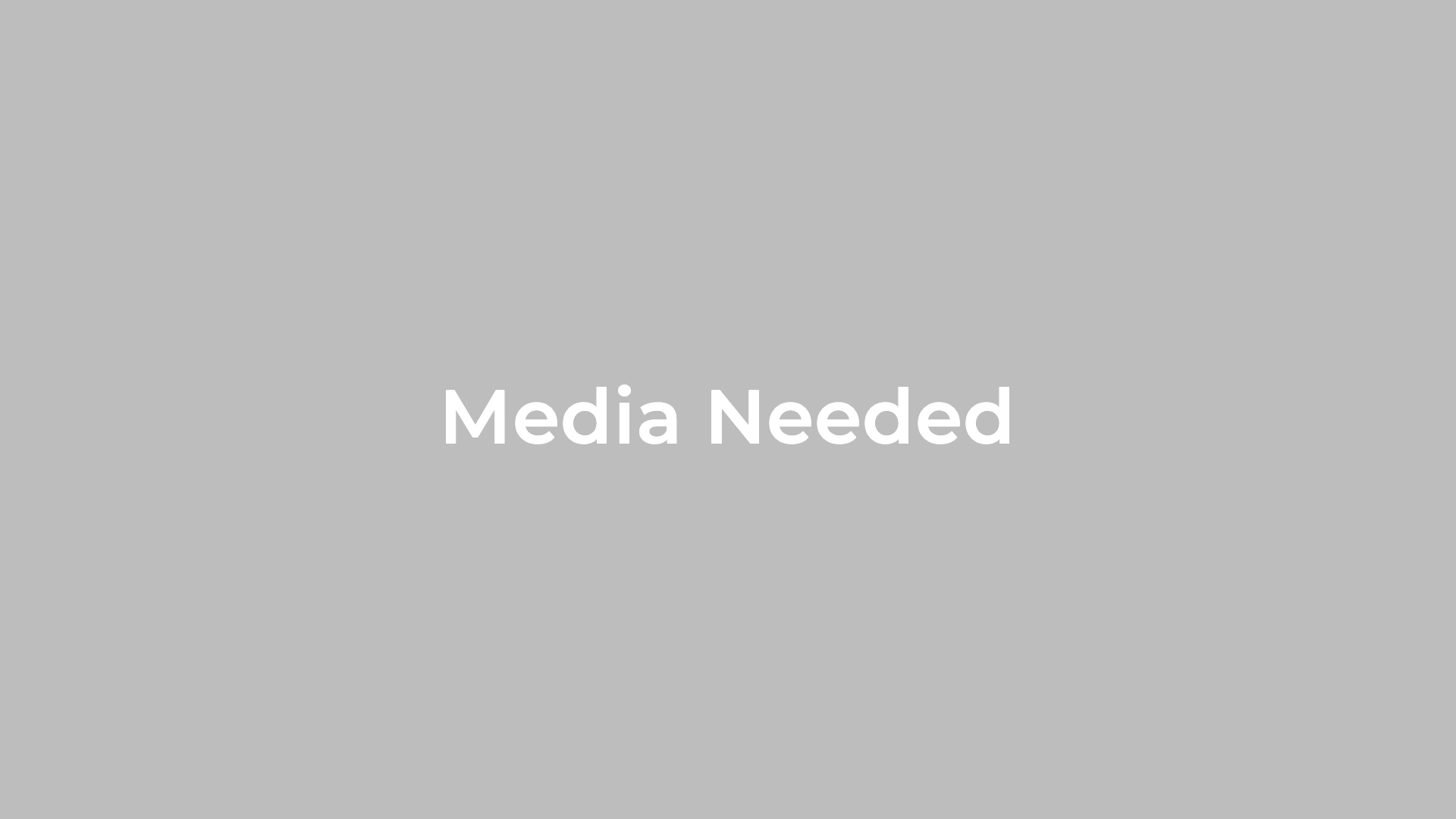 Gray background with "Media Needed" in white, accented by Kent Island Jewelry's 10K Gold Diamond & Ruby Signet Ring motif.